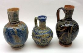 A Group of three Doulton Lambeth Stoneware Miniature Ewers, decorated with stylised floral