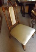 A Victorian Nursing Chair with elegant back barley twists supports, upholstered central back panel