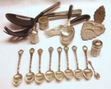 A Mixed Lot of Oriental white metal wares, including two pair of Salad Servers; Lotus Leaf Three