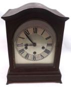 An early 20th Century Mahogany Cased Mantel Clock, with silvered arched dial and circular black