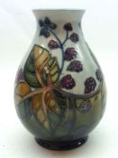 A Moorcroft Baluster Vase, decorated with the “Bramble” design on a pale blue and blue/green/ochre