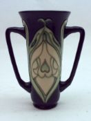 A Moorcroft Two-Handled Vase of tapering circular form, tube-lined with an Art Nouveau style fruit