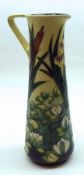 A Moorcroft Ewer, decorated with a Lily Pad/Bulrush design, in colours on a green and lemon