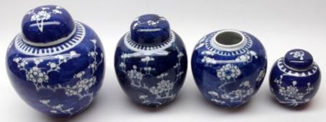 A collection of four Oriental Covered Ginger Jars all decorated in underglaze blue with a prunus