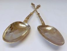 A pair of 19th Century French Silver Apostle Serving Spoons with chased and twist stems with apostle
