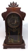 A late 19th Century Gingerbread type Mahogany Cased Mantel Clock, glazed door enclosing a brass