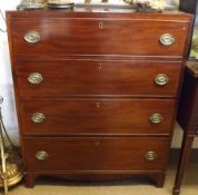 A 19th Century Mahogany Chest of four full length drawers, oval brass plate handles, raised on small