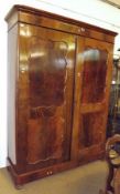 A large 19th Century Mahogany Wardrobe, the moulded cornice to two large panelled doors, the