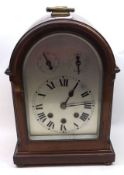 An early 20th Century Mantel Clock with arched top over a silvered arched dial, black Roman
