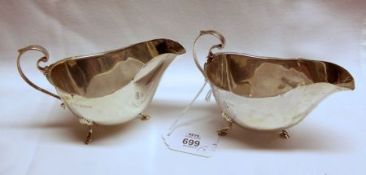 A small pair of George V Sauce Boats of plain design with wavy rims, supported on three shell and