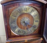 An early 20th Century Mahogany Grandmother Clock, arched top and glazed door enclosing a circular