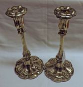 A pair of Victorian previously Electroplated Candlesticks with multi-lobed and loaded circular