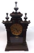 A Mahogany Stained Cased Mantel Clock, crested with three ball finials, glazed front enclosing