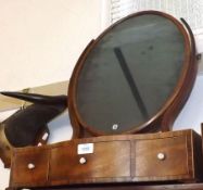 An early 19th Century Dressing Table Mirror, with oval mirror plate, serpentined front with three