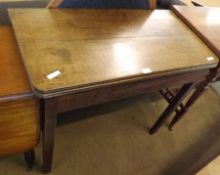 A 19th Century Oak Folding Tea Table, raised on plain square legs, 34” wide