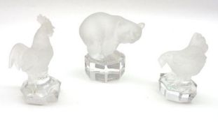 A Group of three Goebel Clear and Frosted Glass Paperweights, modelled as a bear and a cock and hen,