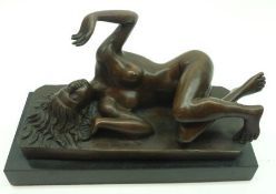 A 20th Century Patinated Bronze Model of a reclining nude, nears signature Milo, raised on a