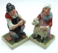 A pair of Staffordshire Figures of the Cobbler and his Wife, each painted in colours, on gilt