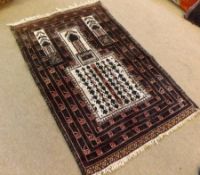 A 20th Century Turkish Prayer Rug, central geometric pattern mainly burgundy field, 4’2” x 2’9”