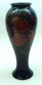 A Moorcroft Vase of tulip baluster form, decorated with a Finches design on a dark blue ground,