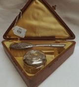 A Cased Silver Mounted Three Piece Christening Set, comprising Hairbrush embossed “Baby” and a