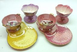 Six Maling Pink/Puce Lustre Leaf-formed Pedestal Sundae Dishes; together with two Maling Pedestal