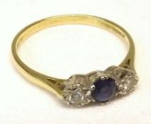 A hallmarked 18ct Gold centre mid-blue small Sapphire and two small brilliant cut Diamond Ring