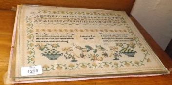 An unframed 19th Century Needlework Sampler, decorated with a floral border and central rows of