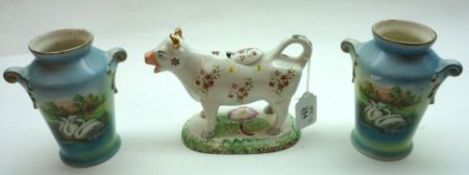 A 19th Century Staffordshire Cow Creamer (horns A/F); together with a pair of Czechoslovakian