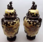 A pair of 20th Century Satsuma Covered Vases of tapering baluster form, the covers with temple dog