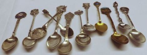 A collection of eleven hallmarked Silver/white metal Souvenir Spoons, some with enamelled finials