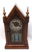 An American Cathedral style Mantel Clock, glazed door enclosing an enamelled dial with alarm