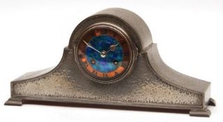 A Tudric Hammered Pewter Cased Mantel Clock of arched form, the circular copper chapter ring with