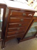 A late Victorian Mahogany Six Drawer Music Cabinet with brass plate handles, raised on tapering