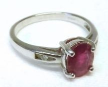 A hallmarked 9ct Gold centre oval Ruby Ring with a small Diamond to each shoulder, the ruby