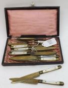 A Boxed set of six small Mother of Pearl handled base metal Forks and six matching Knives