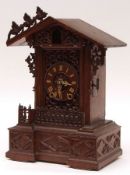 A 19th Century Swiss Cuckoo Clock with arched top applied with foliate mounts, central aperture