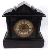 A Victorian Black Marble Mantel Clock with Ansonia movement striking on a gong, the front with
