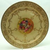 A Royal Worcester gilt decorated Plate, with central round floral painted panel, marked to base “The