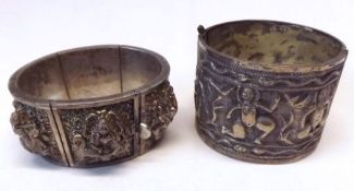 A heavy Ceylonese Figure Embossed White Metal Panelled Bangle and a further Ethnic Bangle (2)