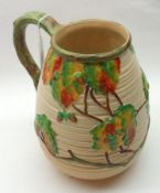 A Carlton Ware Decorative Jug, decorated with Autumn Tree scene and a branch-formed handle on a