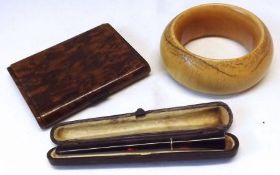 A Mixed Lot including, an early 20th Century Ivory Bangle (heavily stained); a Green Cigarette