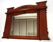 A late 19th Century Oak Framed Bevelled Overmantel Mirror, decorated with inlaid panels in the Art