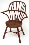 An 18th or early 19th Century Elm Seated Stick Back Chair with crinoline stretcher, raised on turned
