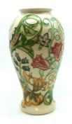 A Moorcroft Baluster Vase, decorated with the “Golden Lily” design on a white ground, impressed