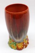 A Clarice Cliff “My Garden” Circular Vase of tapering form, with red and ochre streaked body and