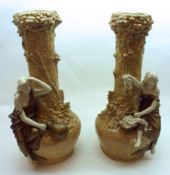 A pair of late 19th/early 20th Century Continental Spill Vases, decorated with seated young