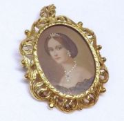 A 20th Century high grade precious metal Pendant/Brooch, hand painted to the centre with a head