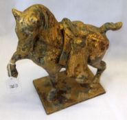 A 20th Century Gilded Bronze Model of a Tang type horse, standing on an integral base with one front