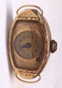 A Ladies Vintage 14ct Gold Cased Wristwatch with engraved surround and bezel, 1.1” x.7” overall (A/